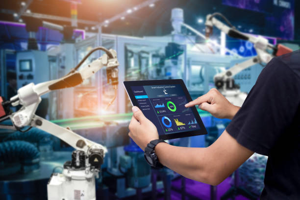 Smart industry control concept Hands holding tablet on blurred automation machine as background factory stock pictures, royalty-free photos & images