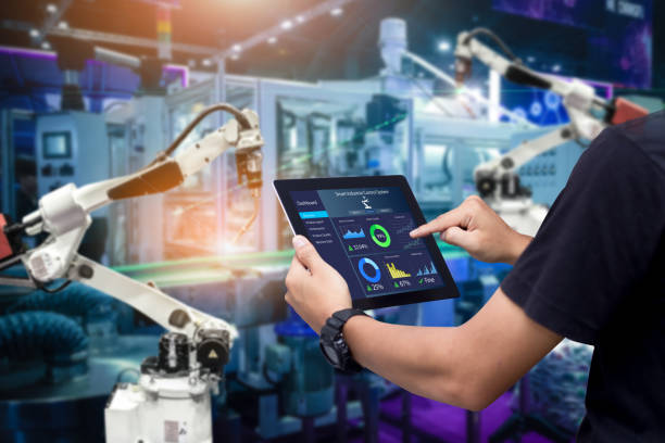 Smart industry control concept Hands holding tablet on blurred automation machine as background industrial robot stock pictures, royalty-free photos & images