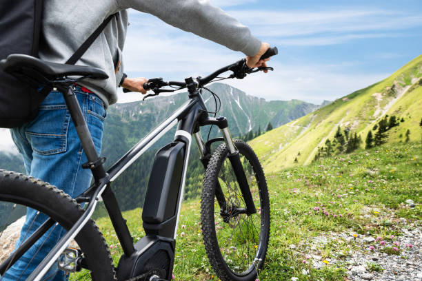 main on mountain with his bike - electric bicycle imagens e fotografias de stock