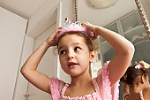 Girl putting crown on her head