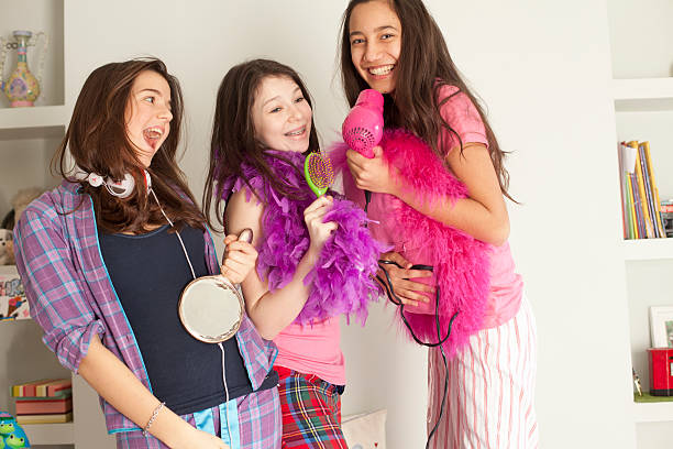 teenage girls singing , wearing pajamas  slumber party stock pictures, royalty-free photos & images