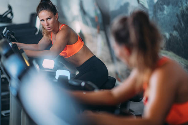 istock Woman Exercising on Cycling Machine 1171909131