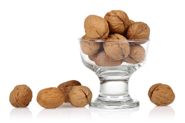 istock Whole walnuts in the glass bowl isolated 1171910264