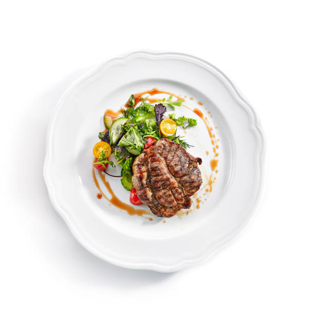 istock Pork Neck Steak with Mixed Salad on White Restaurent Plate 1171910887