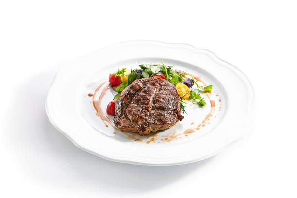 istock Pork Neck Steak with Mixed Salad on White Restaurent Plate 1171910938