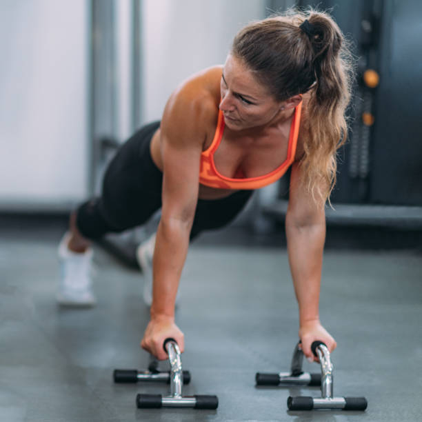 istock Female Athlete Doing Push-Ups in The Gym 1171911895