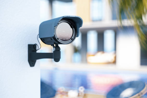 Surveillance Camera Outside Summer Villa Surveillance Camera Outside Summer Villa. 3D Render big brother orwellian concept stock pictures, royalty-free photos & images