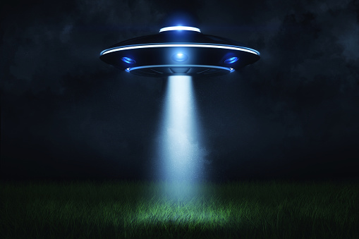 3d rendering of a UFO at night with a beam of light coming out of the hatch and lighting a landing point in the green grass. Visit from another planet. Universe is mystery. Close encounter.