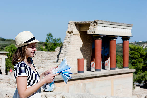 woman looking and holding a map in front of temple  knossos photos stock pictures, royalty-free photos & images