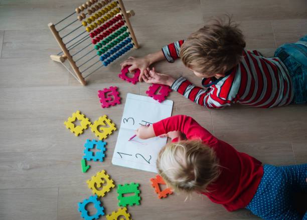 istock boy and girl learn to count and write numbers 1171916306