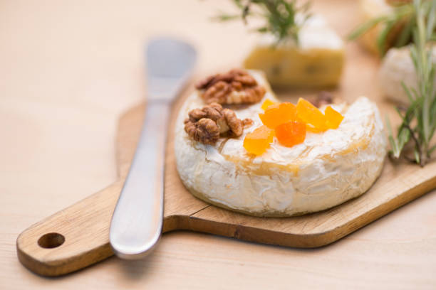 istock Camembert cheese on wooden plate 1171916416