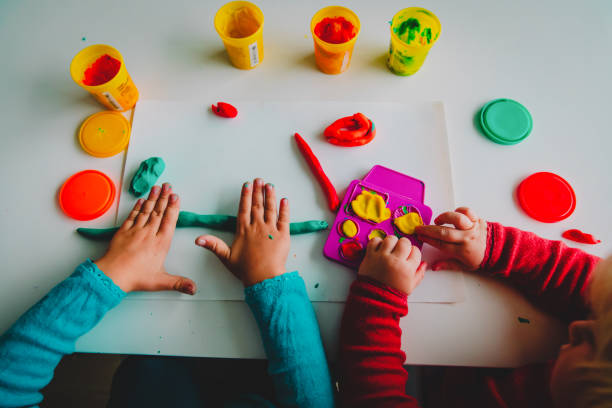 istock kids play with clay molding shapes, learning and play 1171916467