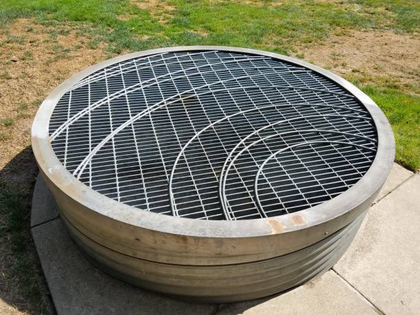 istock circular metal barbeque grill on cement near grass 1171917916