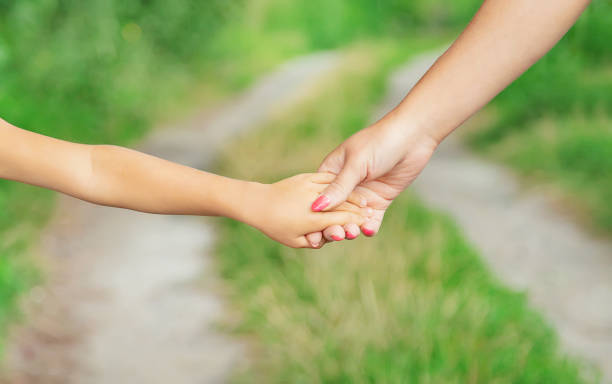 istock child goes hand in hand with his mother. Selective focus. 1171918096
