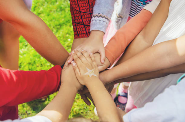 istock children folded their hands together, play on the street. Selective focus. 1171918104