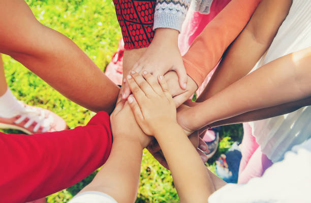 istock children folded their hands together, play on the street. Selective focus. 1171918110