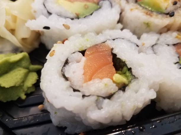 istock salmon and avocado and rice sushi rolls 1171918269
