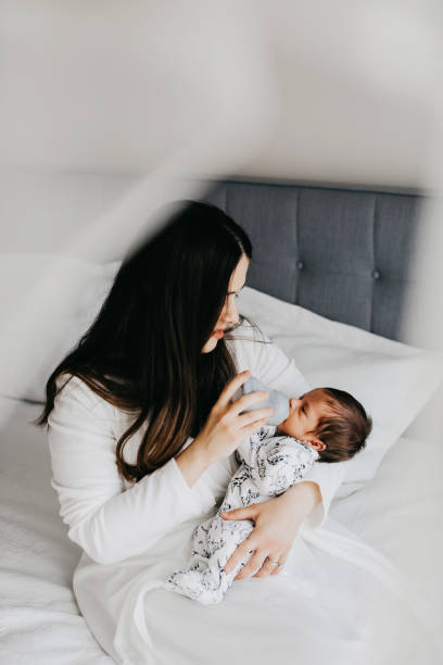 istock Smiling mother with sleeping newborn son on 1171918606