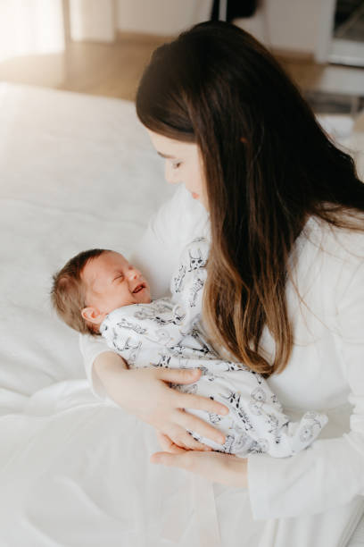 istock Smiling mother with sleeping newborn son on 1171918757