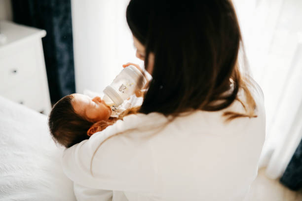 istock Smiling mother with sleeping newborn son on 1171920240