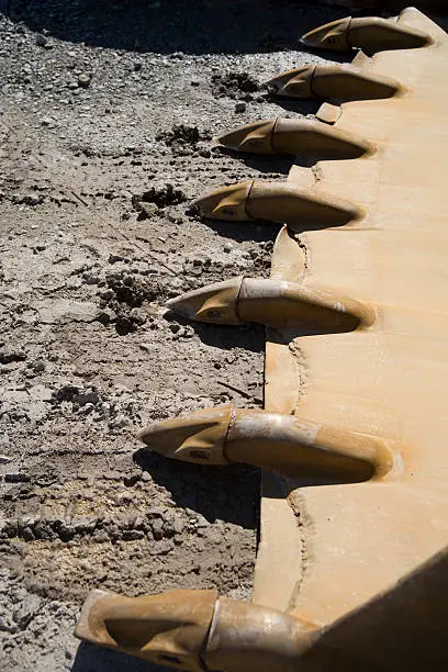 Photo of old and tired bucket teeths on the ground