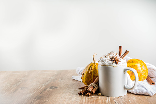 Autumn pumpkin spice latte with cinnamon sticks and anise stars