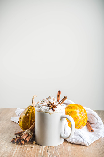 Autumn pumpkin spice latte with cinnamon sticks and anise stars