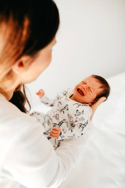 istock Smiling mother with sleeping newborn son on 1171921118