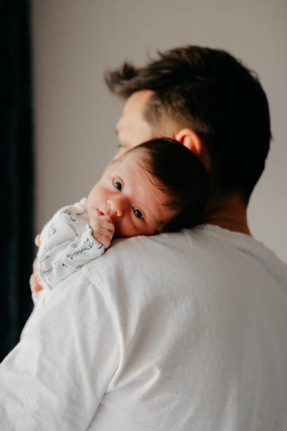 istock Smiling father with sleeping newborn son on 1171921202