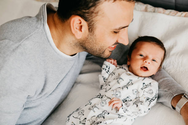 istock Smiling father with sleeping newborn son on 1171921502
