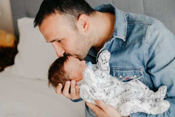 istock Smiling father with sleeping newborn son on 1171921915