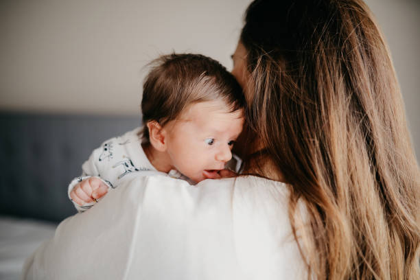 istock Smiling mother with sleeping newborn son on 1171922688