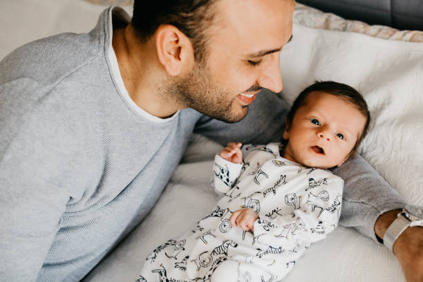 istock Smiling father with sleeping newborn son on 1171922865