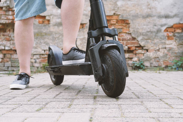 istock legs of unrecognizable man with electric kick scooter or e-scooter 1171922923