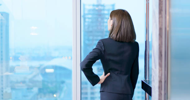 istock business woman gaze through window 1171923270
