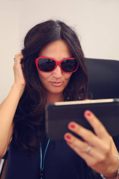 istock Mature woman with red sunglasses 1171923368