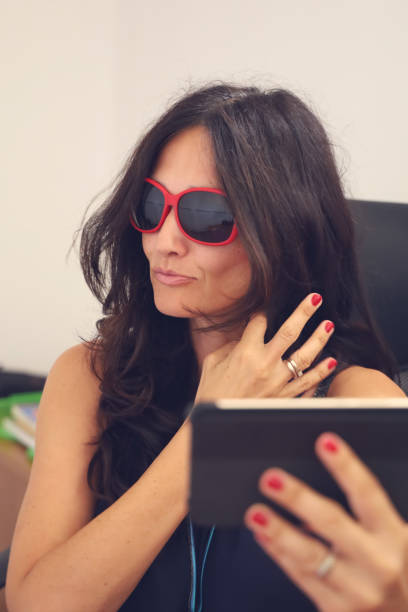 istock Mature woman with red sunglasses 1171923369