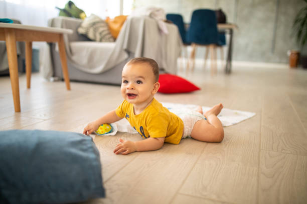 istock Smiling baby boy crawling at home 1171924231