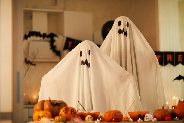 istock Children in ghost costumes at party 1171924376