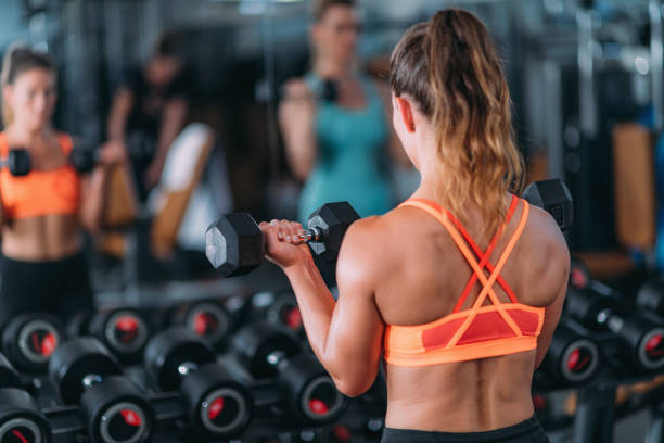 istock Friends Exercising with Weights in the Gym 1171924842