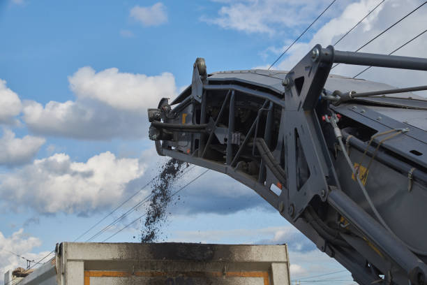 istock Loading old asphalt onto a dump truck. Road repair work 1171925724