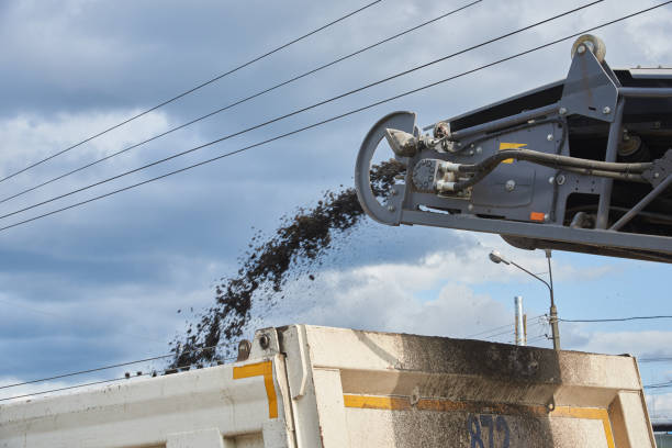 istock Loading old asphalt onto a dump truck. Road repair work 1171925725