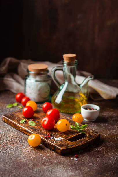 istock Red and yellow fresh tomatos, basil and olive oil 1171925810