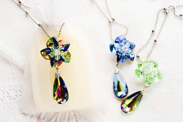 istock Crystal flower necklace on white fabric background 1171926932