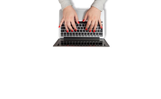Female hands with red nails working on laptop isolated on white background. Mockup for business concept or office desktop