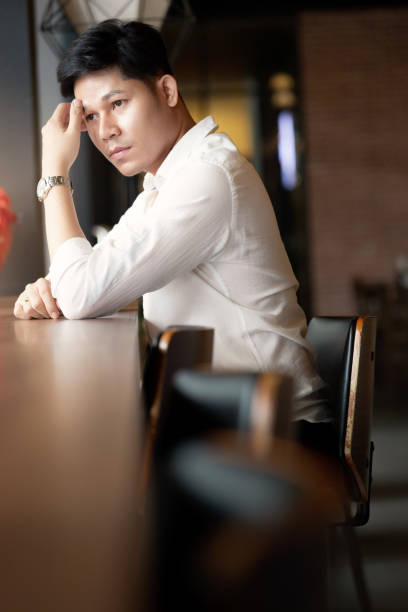 istock Young handsome Asian man sitting with confidence 1171927669