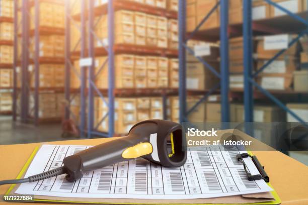 Barcode Scanner In Front Of Modern Warehouse And Scanning Code Stock Photo - Download Image Now