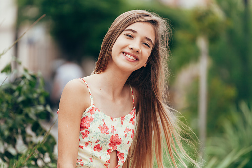 Outdoor portrait of 12 years old girl with long hair