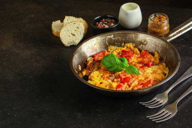 istock scrambled eggs with tomatoes - breakfast delicious and healthy, menu concept. food background. copy space 1171930057