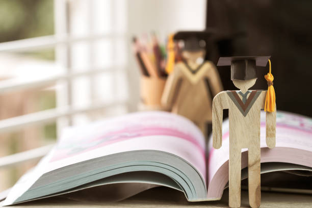 istock Education knowledge learning study abroad international Ideas. People Sign wood Graduation celebrating cap on textbook in library,Alternative studying distant for learn.Back to School in successful 1171931064
